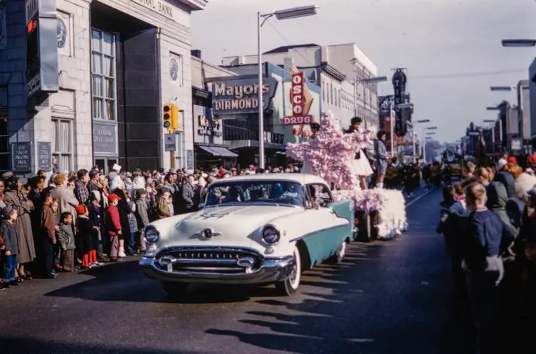 a crowd of people watching a parade go by